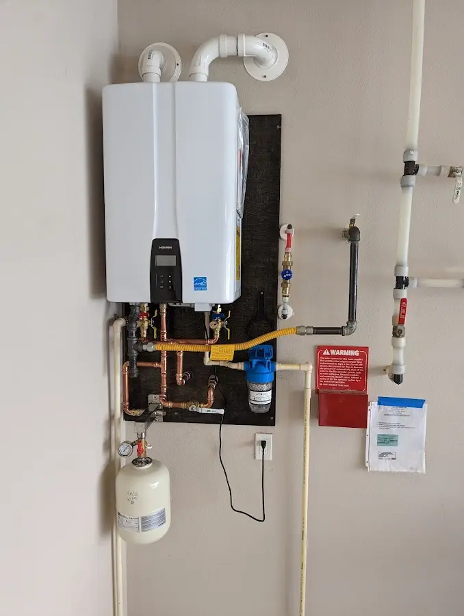 Professional plumber installing copper piping in a Crittenden home